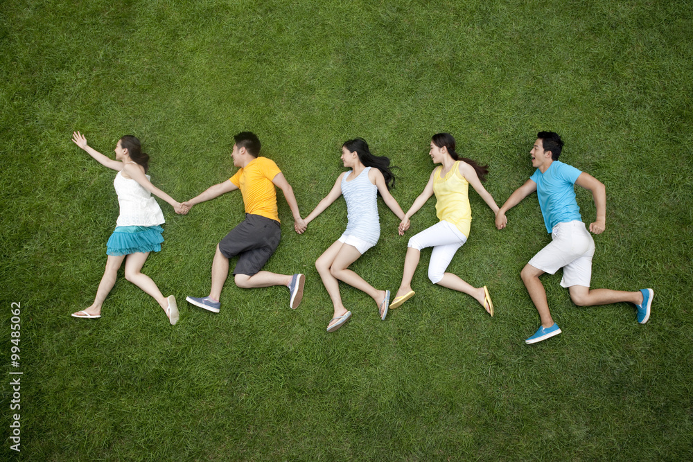 young people imitating running on meadow