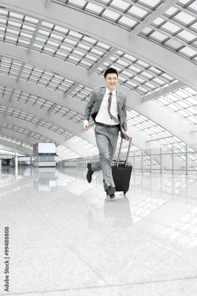 Young businessman in a hurry at the airport