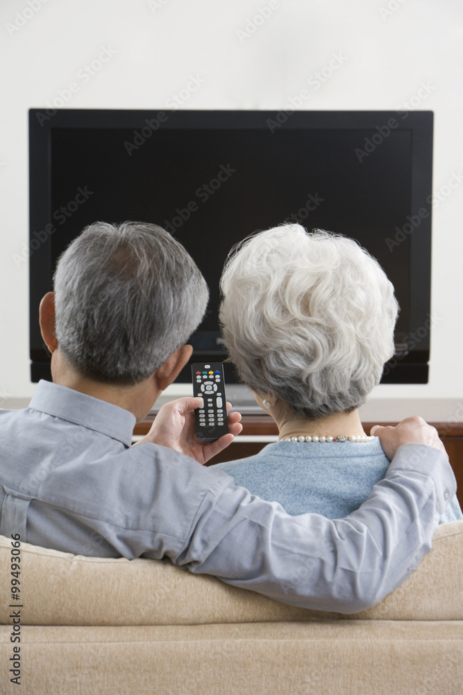 Elderly couple in front of widescreen television