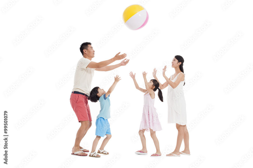 Happy family playing beach ball