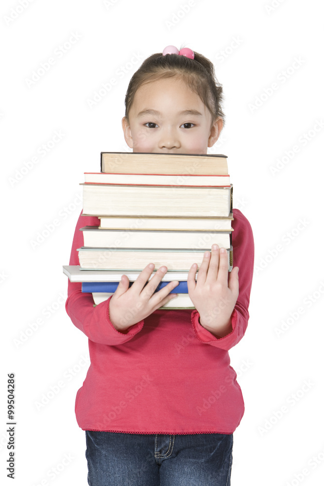 Young girl holding a large stack of books