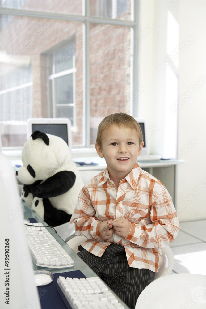 Boy Sitting At Computer Desk