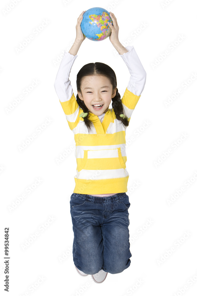 Young girl jumping with a globe