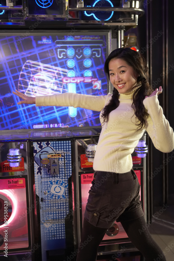 Teenage Girl  On Dancing Game At Arcade