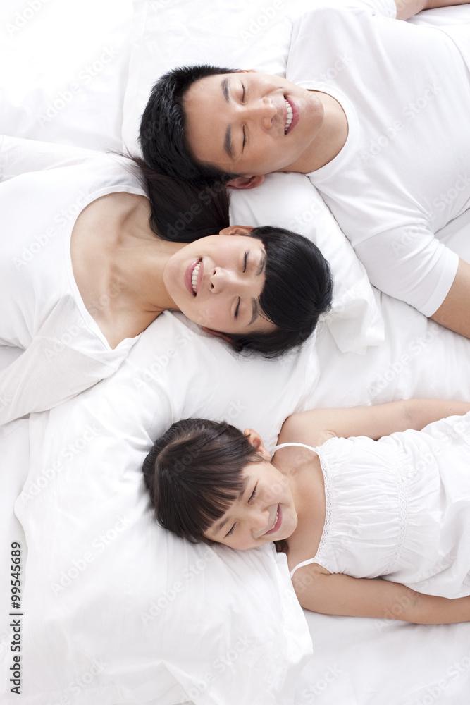 幸福的一家人躺在床上