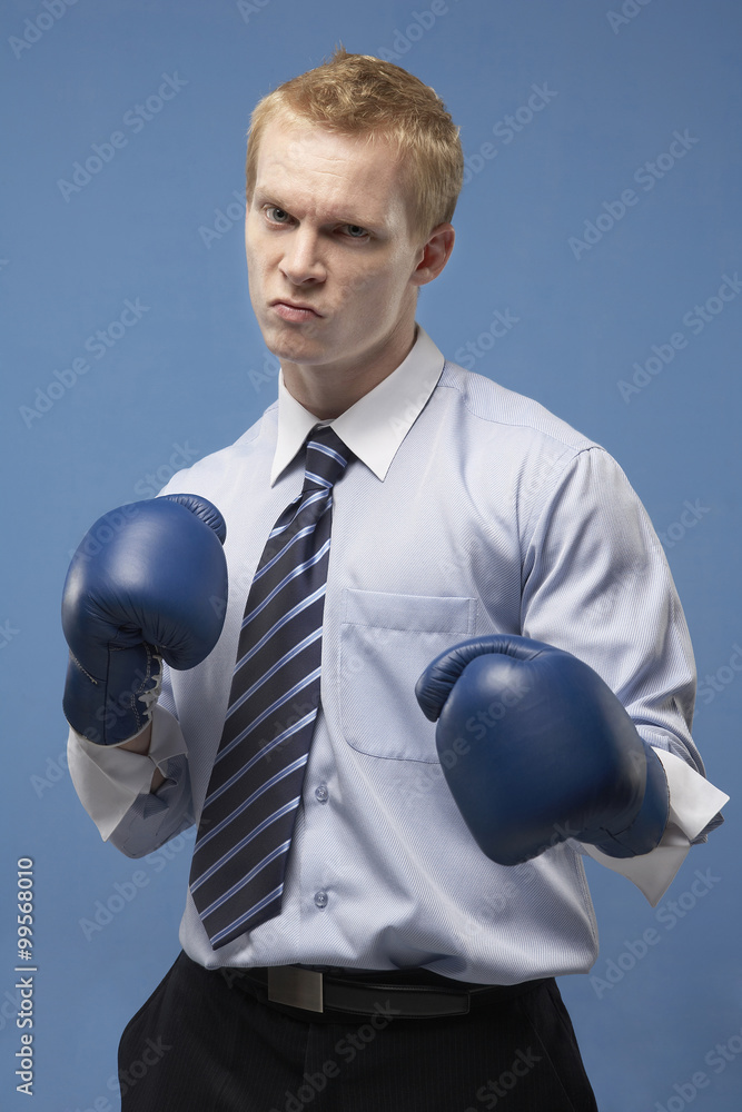 Businessman Wearing Boxing Gloves With Raised Fists