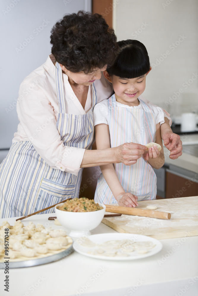 快乐的祖母和孙女正在包饺子