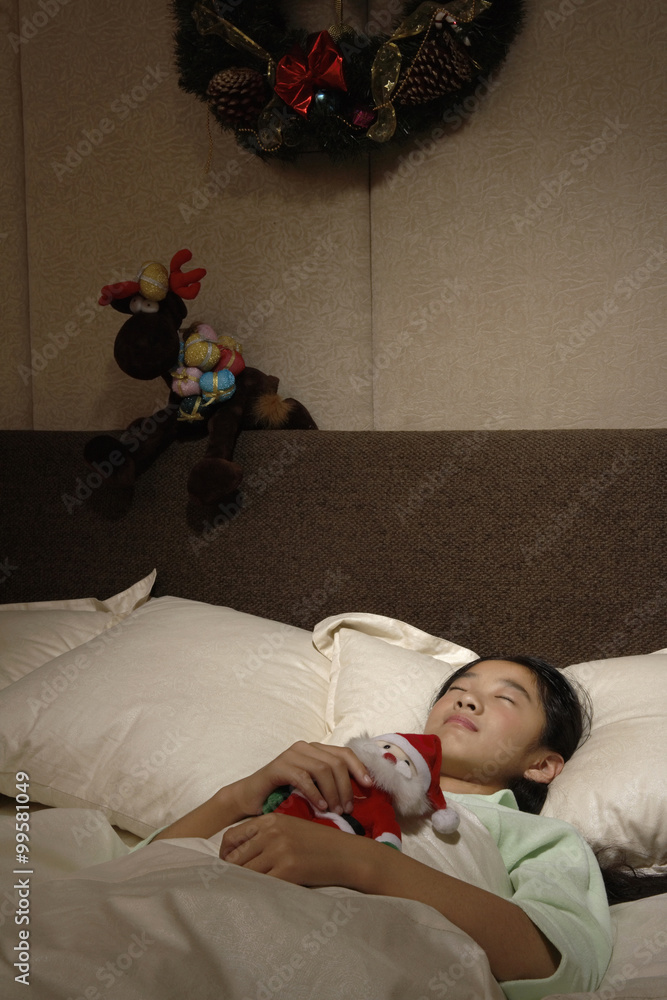 Girl Asleep In Bed With Toy Santa Claus
