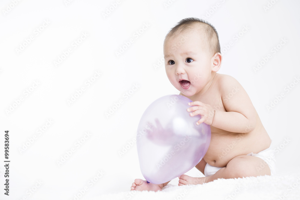Cute baby boy playing balloons