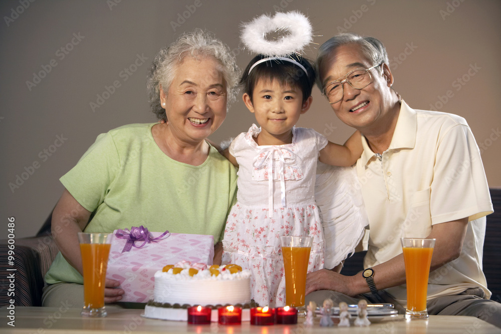 Grandparents Posing With Their Granddaughter Who Is Dressed Up As An Angel