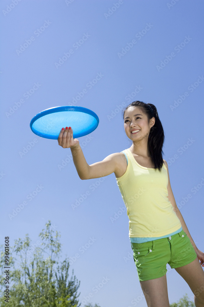 Young woman throwing a Frisbee