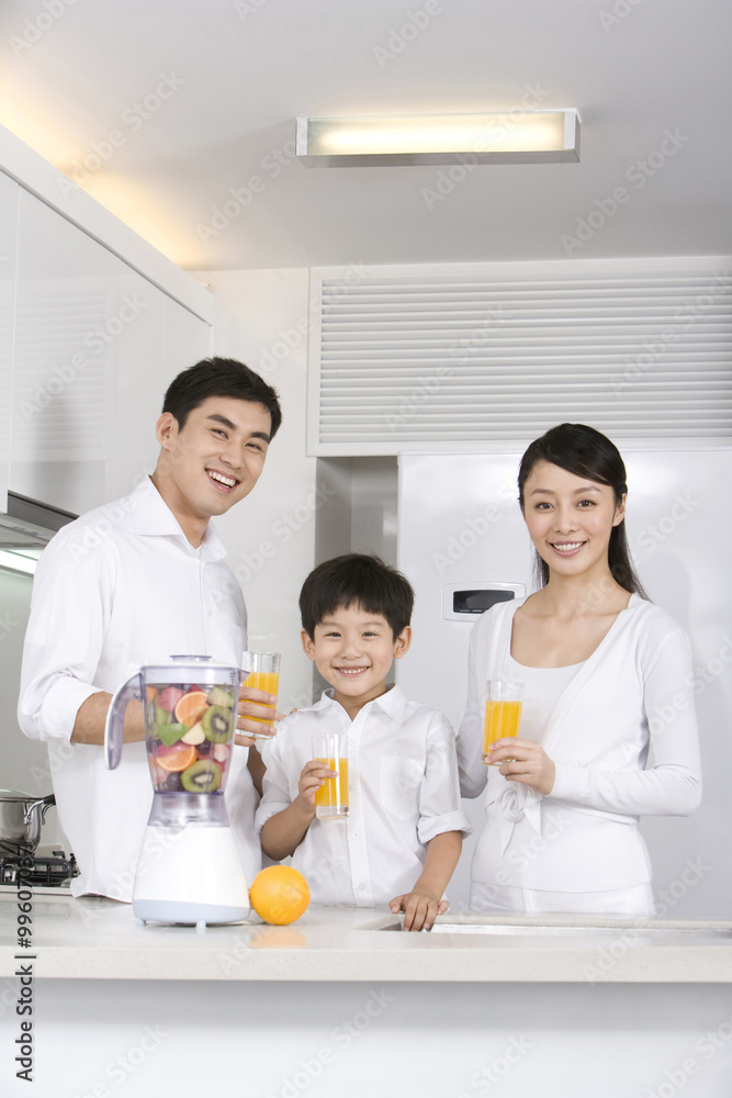 Family drinking  fresh fruit juice in kitchen