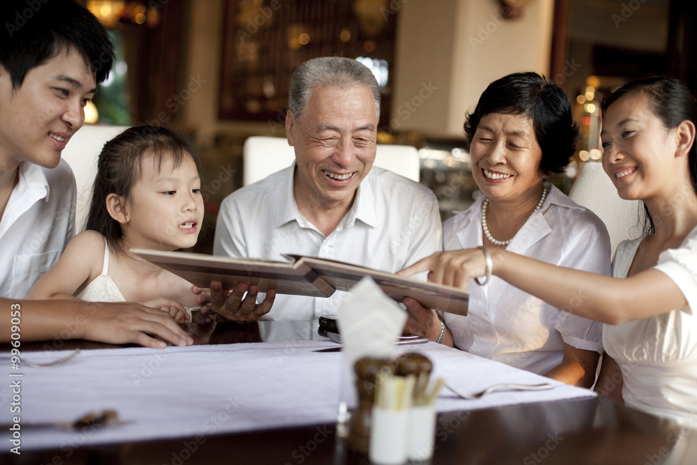 Happy family looking through a menu