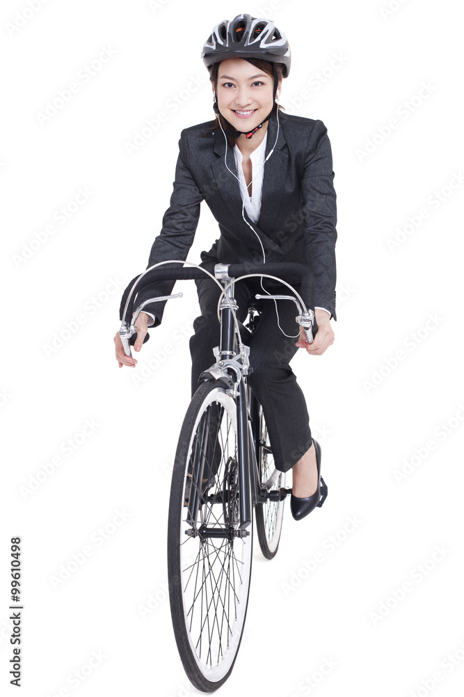 Portrait of young businesswoman riding a bike