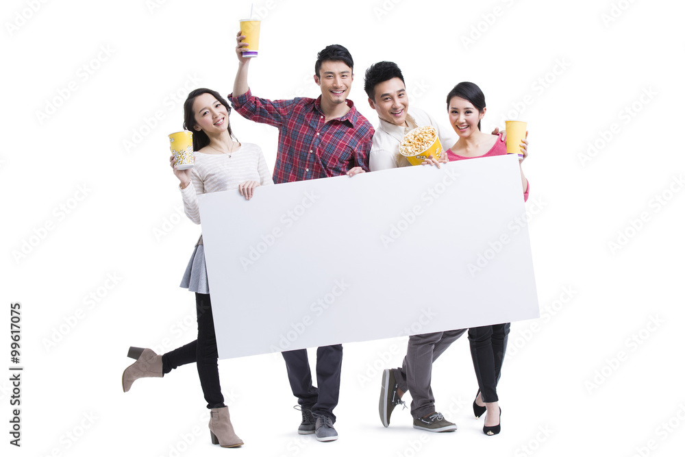 Young adults showing white board with popcorn in hands
