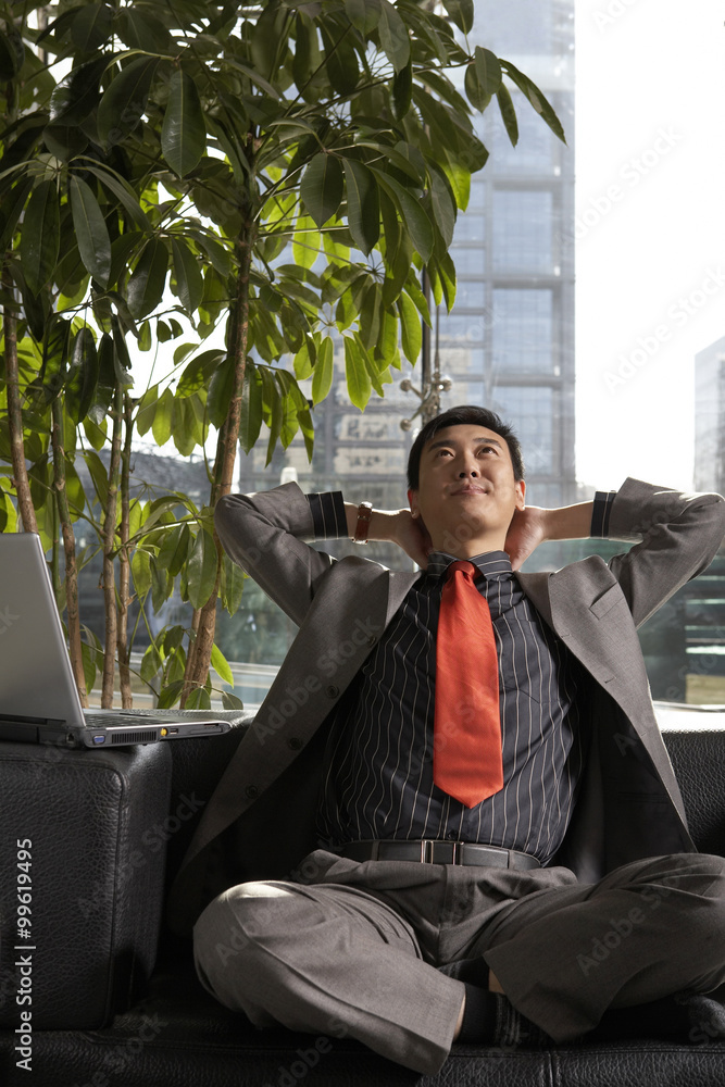 Businessman Resting With Hands Behind His Head