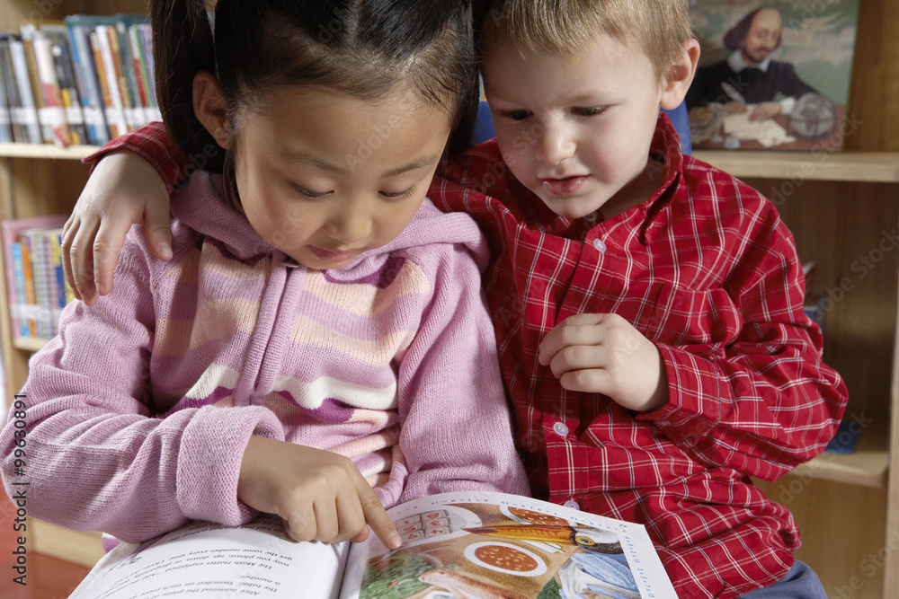 Children Reading Book Together
