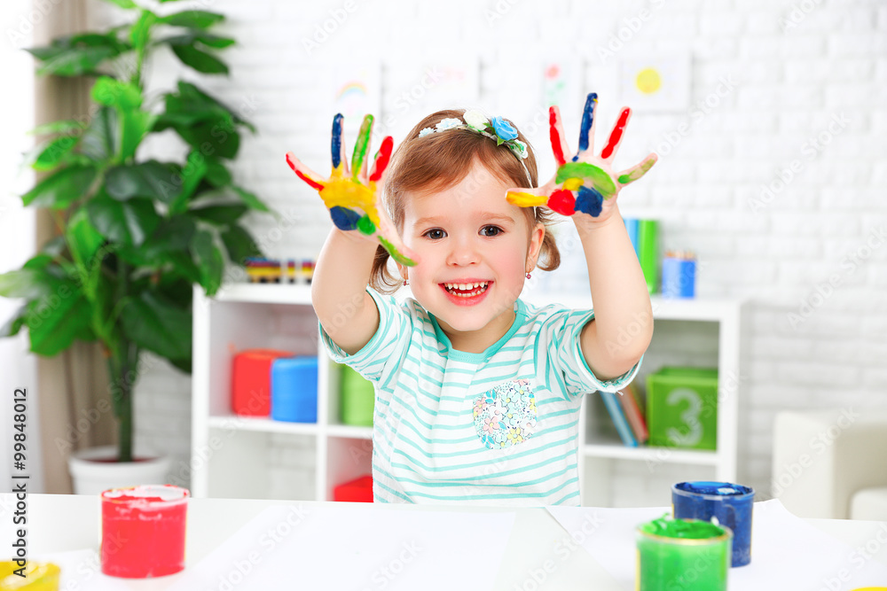 hands in colored paint  happy child girl