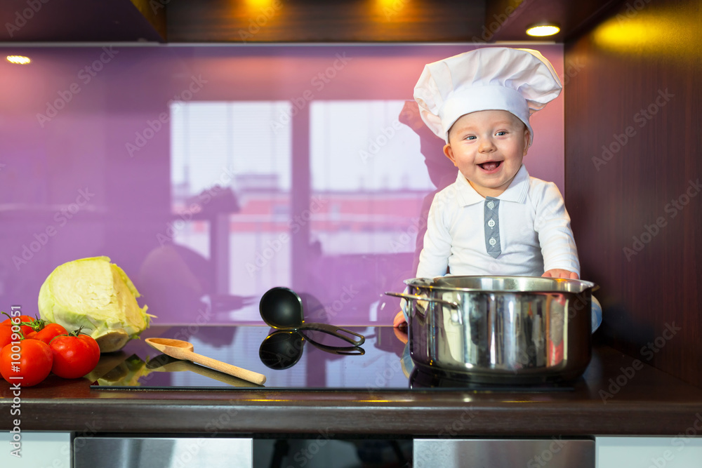 Baby chef cooking in the kitchen