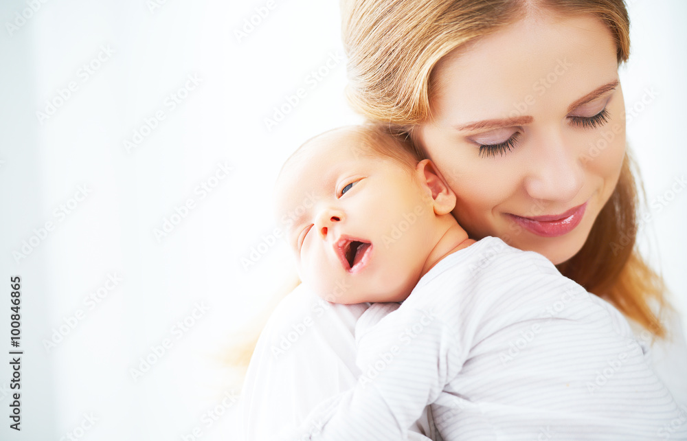 newborn baby in tender embrace of mother