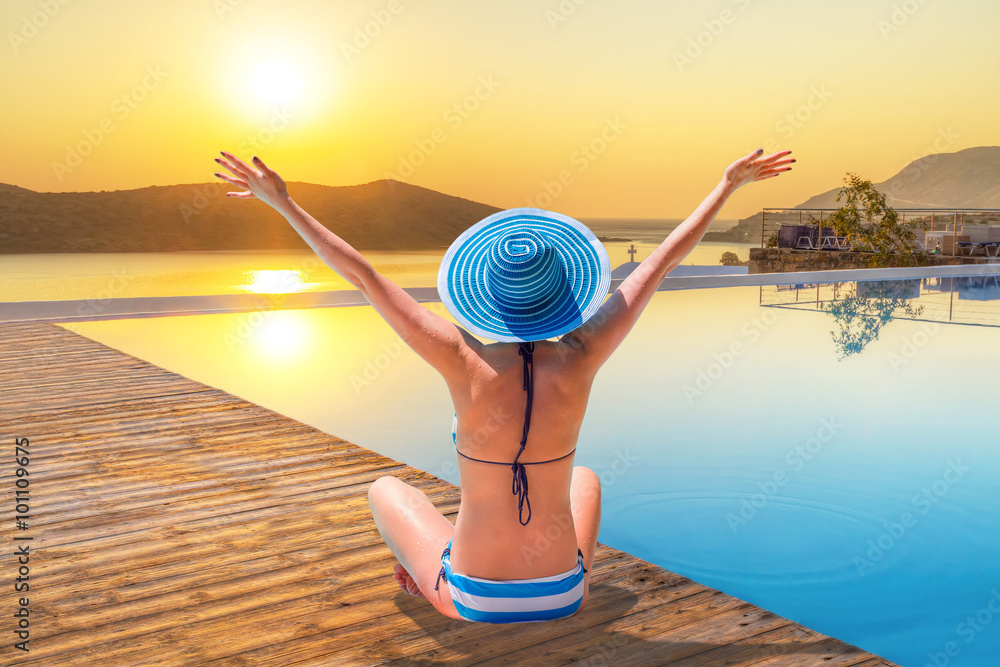 Woman in hat enjoying sun holidays in Greece