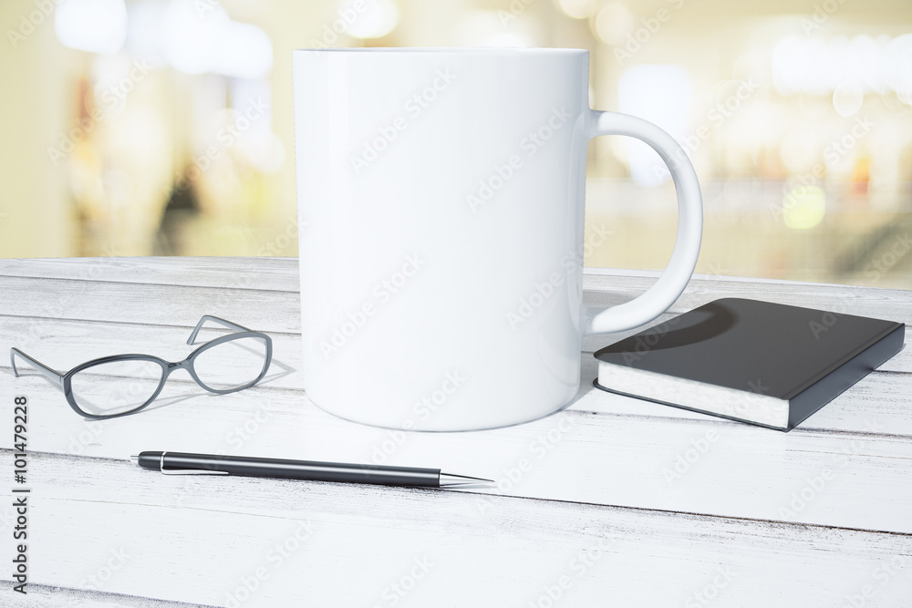 Blank white cup with diary, pen and eyeglasses on white wooden t