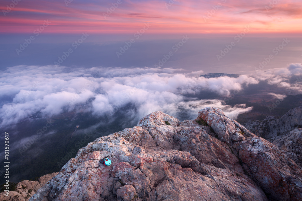 Beautiful landscape on the top of mountains with sea, colorful sunset and low clouds. Nature backgro