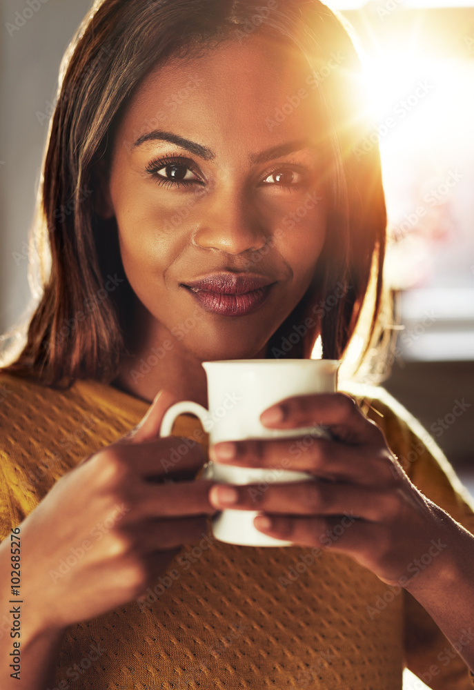 Attractive woman enjoying an energising coffee
