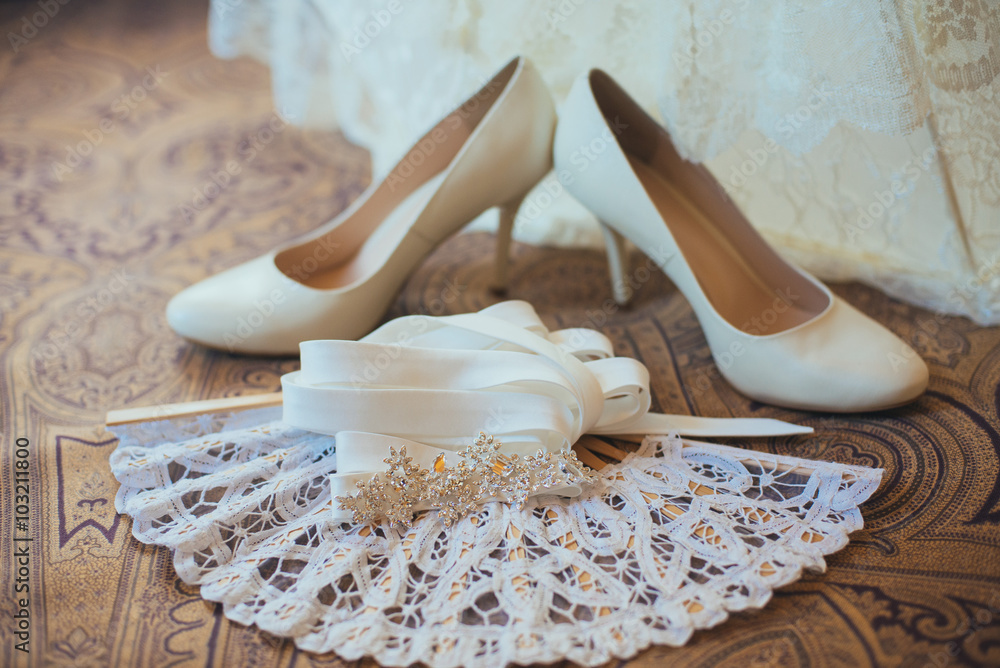 white bridal shoes on the wooden floor