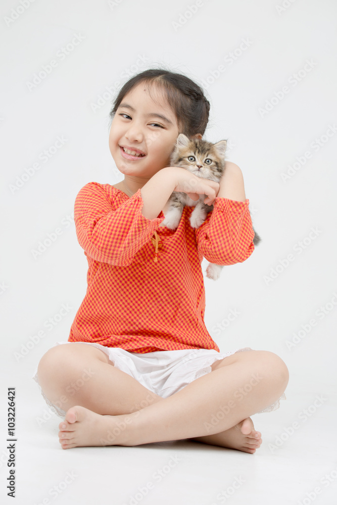 Little Asian girl hugging lovely Persian kitten on isolated