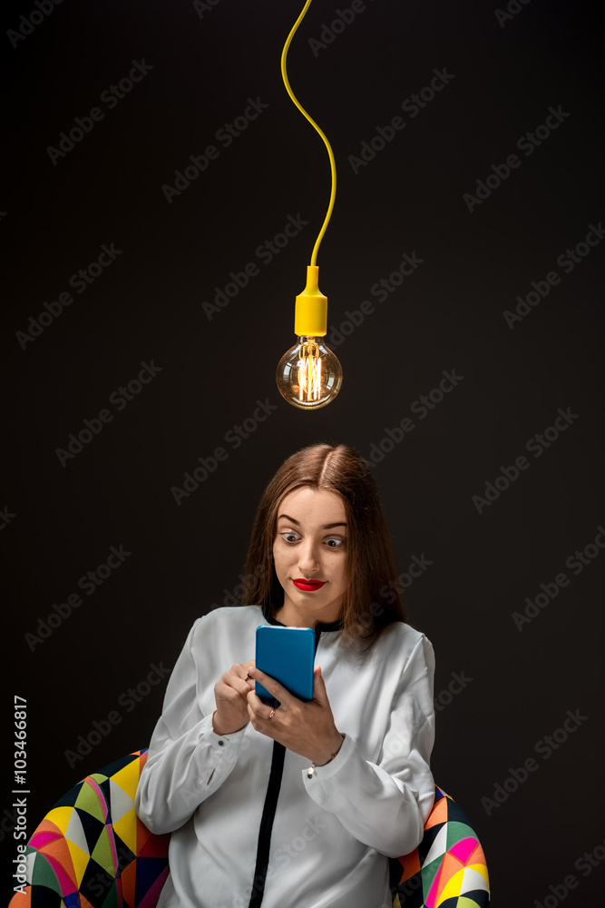 Woman with smart phone having idea
