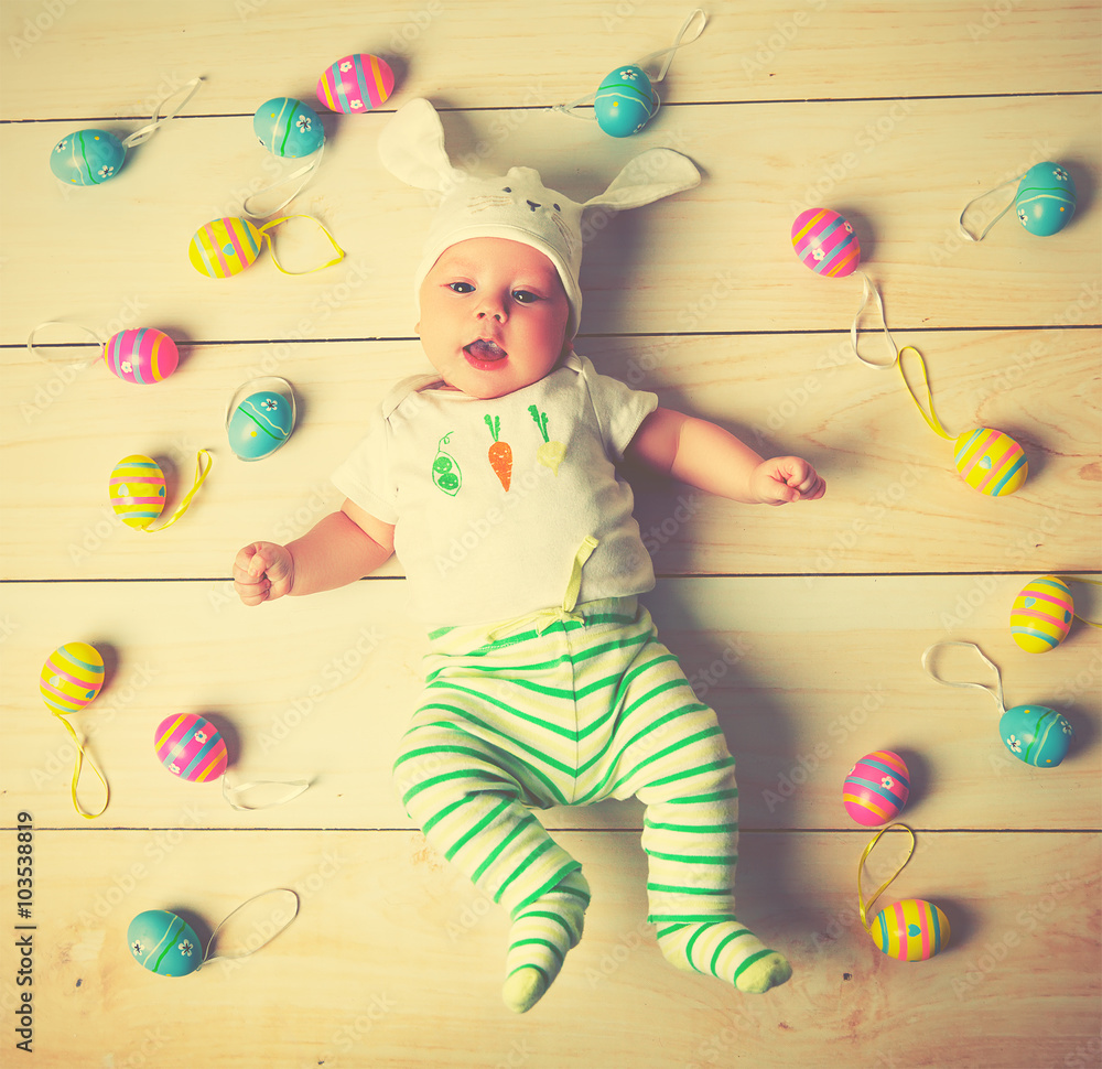 拥有复活节兔子耳朵和鸡蛋的快乐宝宝