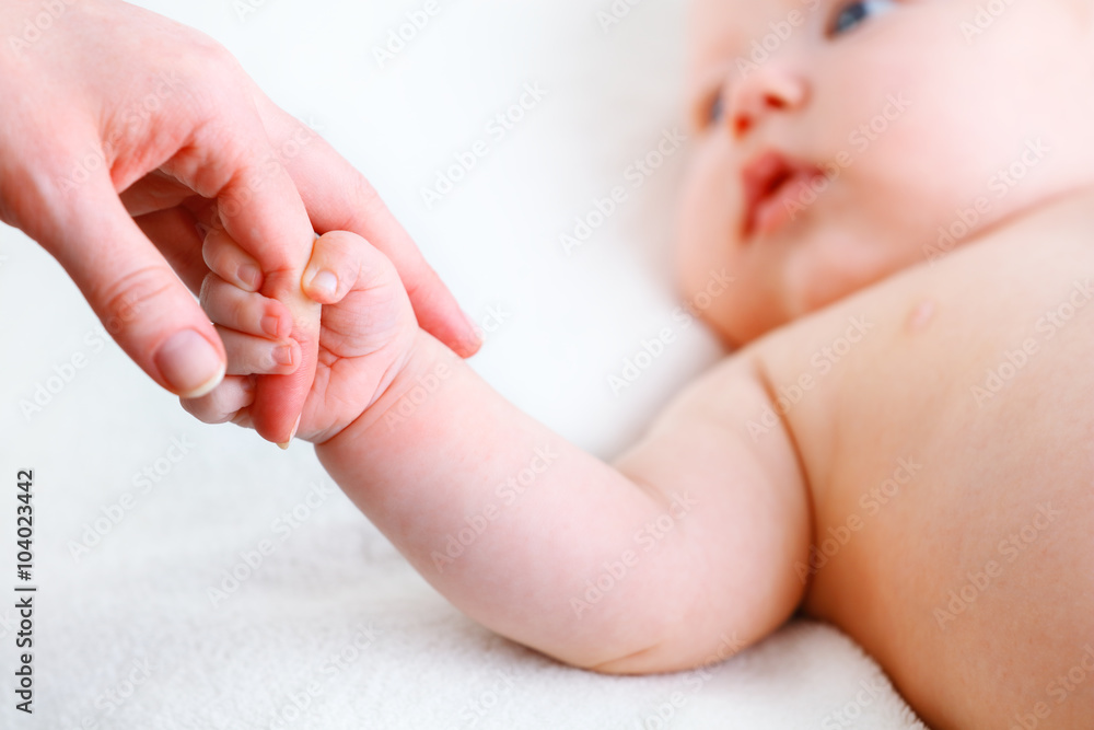 concept of parental love. baby hand holding  finger of mother