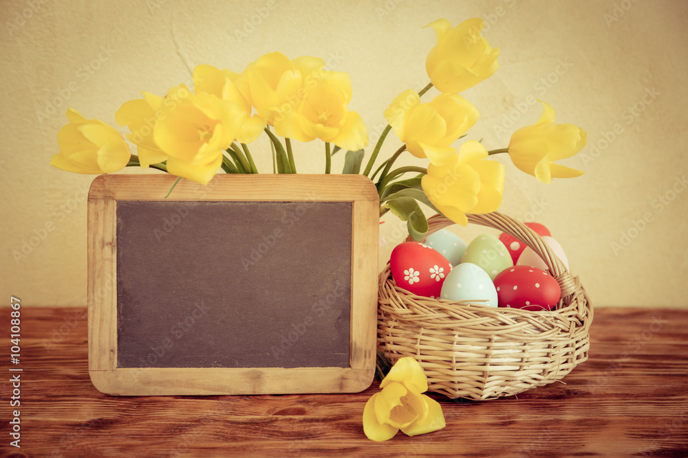 Easter eggs, flowers and blackboard blank