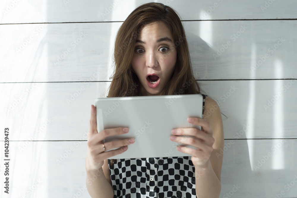 Young women are surprised to see the electronic tablet