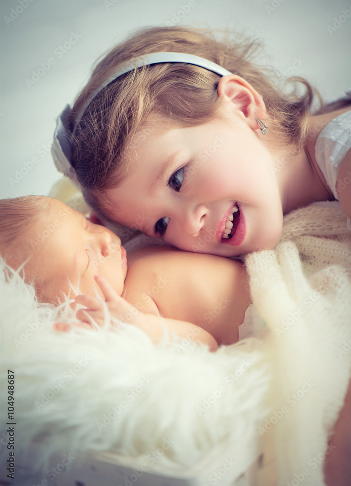 children sister and brother  newborn baby on a light