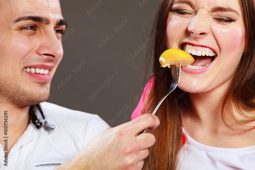 微笑的丈夫用苹果喂养幸福的妻子。