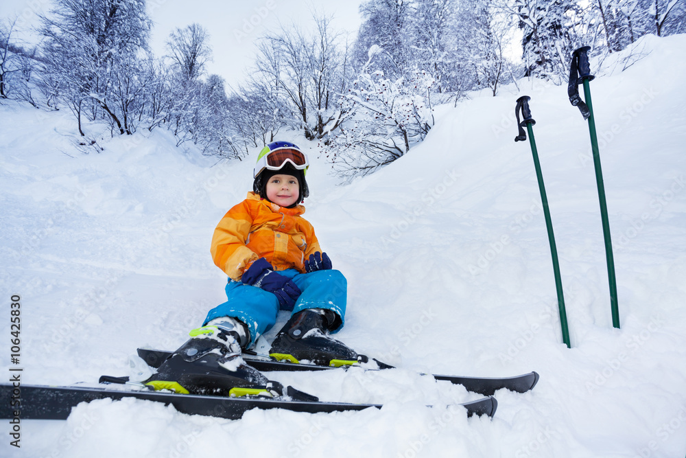 滑雪小男孩穿着滑雪服休息