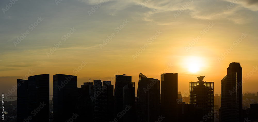 Silhouettes of Singapore skyscrapers at sunset