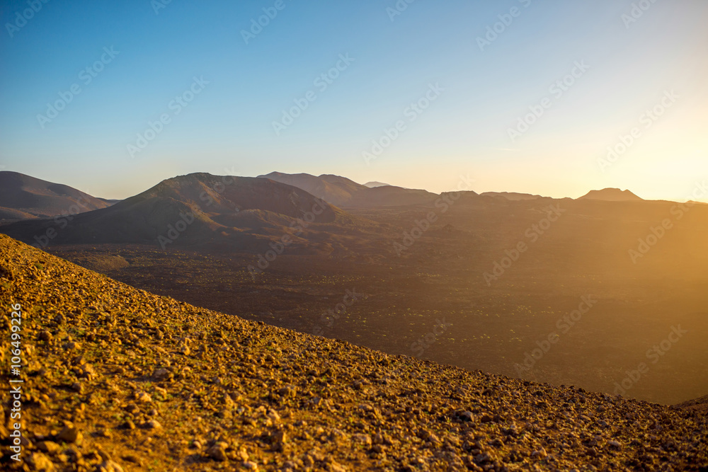 Volcanic landscape on the top of Caldera Blanca volcano on the sunset on Lanzarote island in Spain
