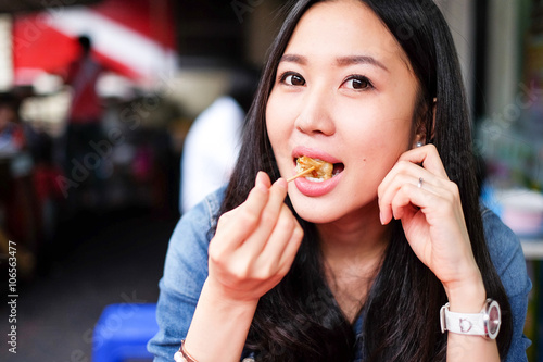 Woman eating Chinese Shanghainese steamed dumpling buns