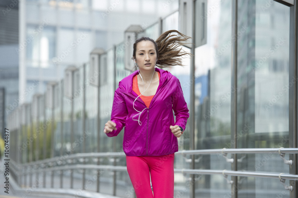 Asian women are jogging while listening to music