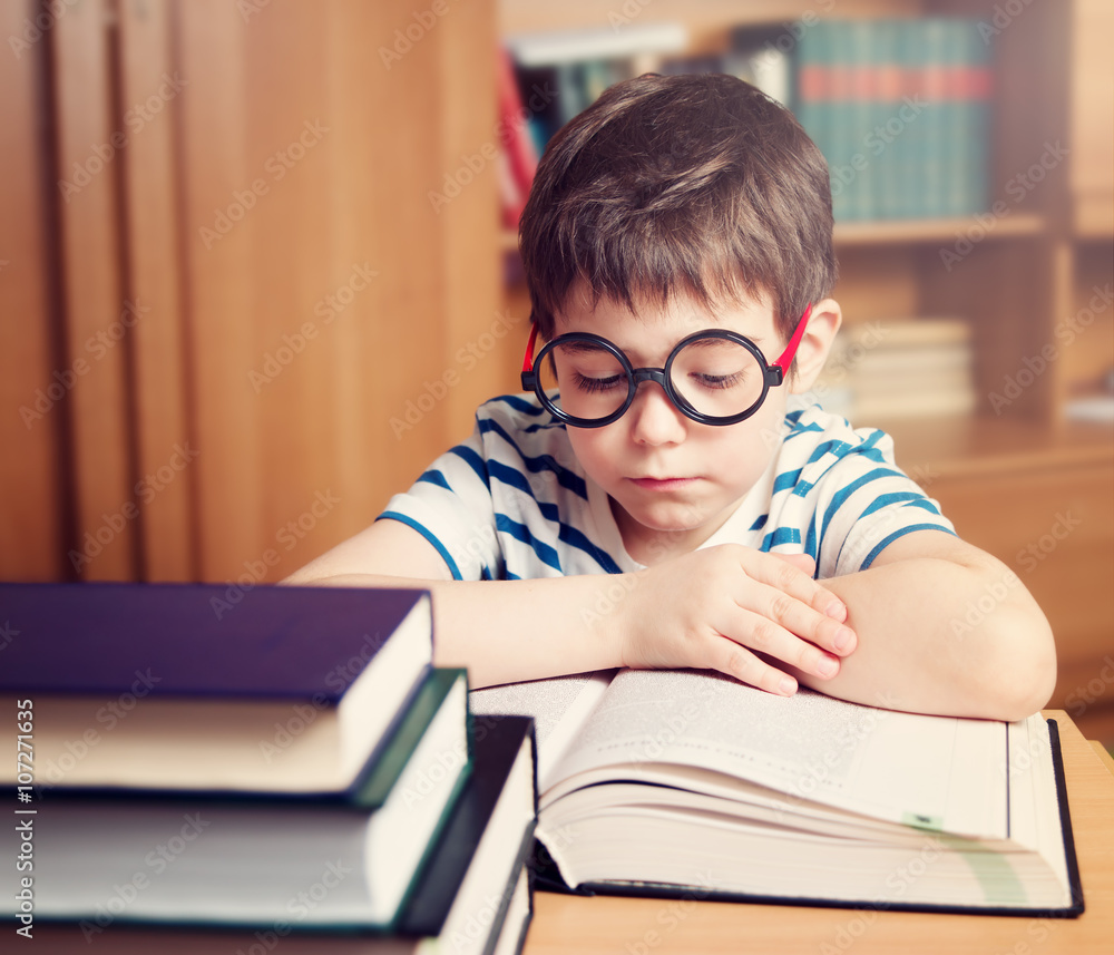seven years old child reading a book at home
