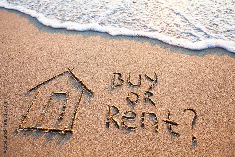 买房或租房的概念，沙滩上的文字，房地产