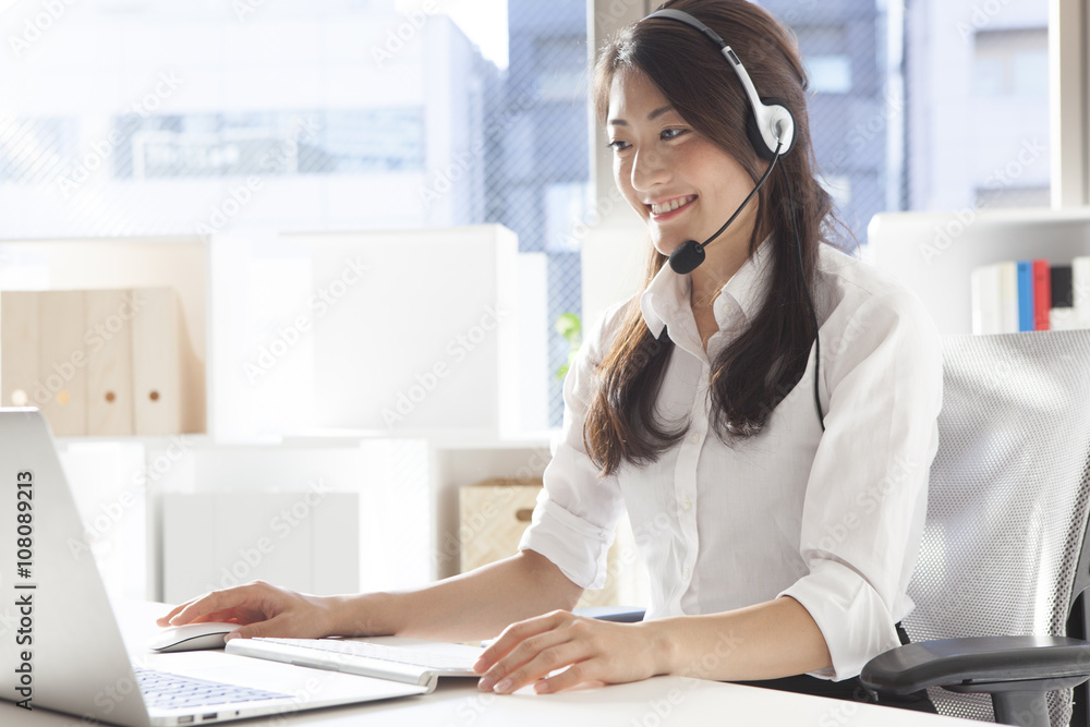Young women are the correspondence of the customer with the headset