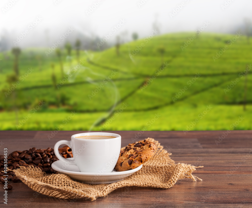 Coffee cup on wooden table, plantations background