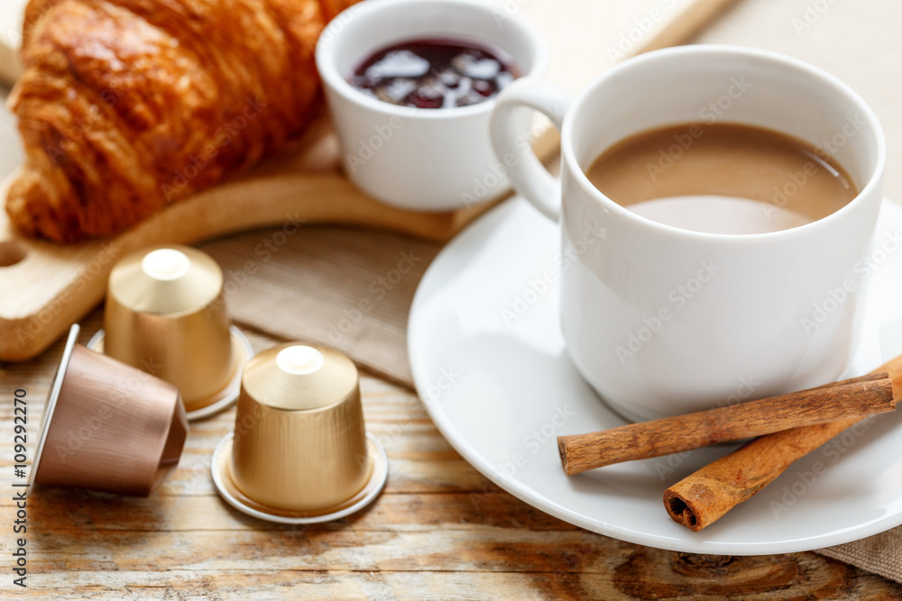 Breakfast with coffee and croissants on wooden table