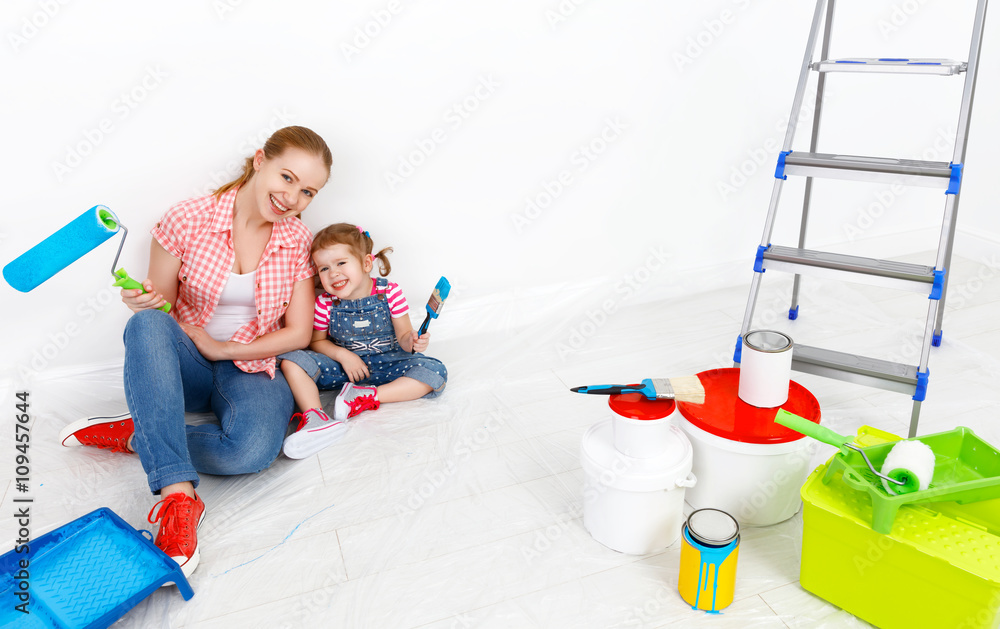 幸福的家庭母亲和孩子女儿进行维修，油漆墙