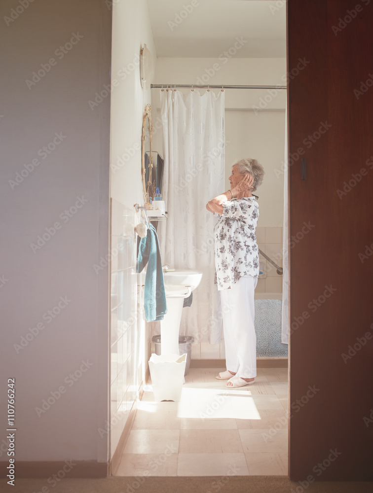 Senior female getting ready in bathroom