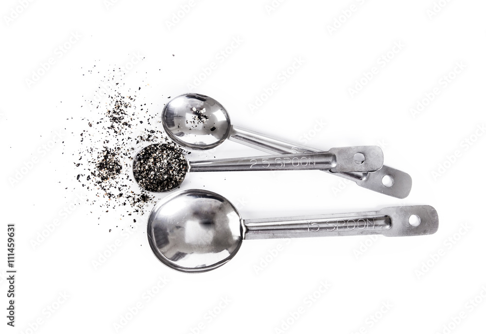 Group of Steel measuring spoons with food seasoning from sesame